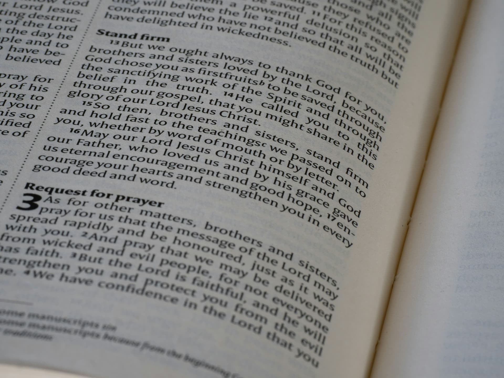 Open Bible and prayerful hands